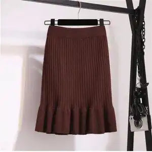 Ruffled high waisted skirt in a flowing design, showcasing layers and fabric texture from M Chic Boutique.