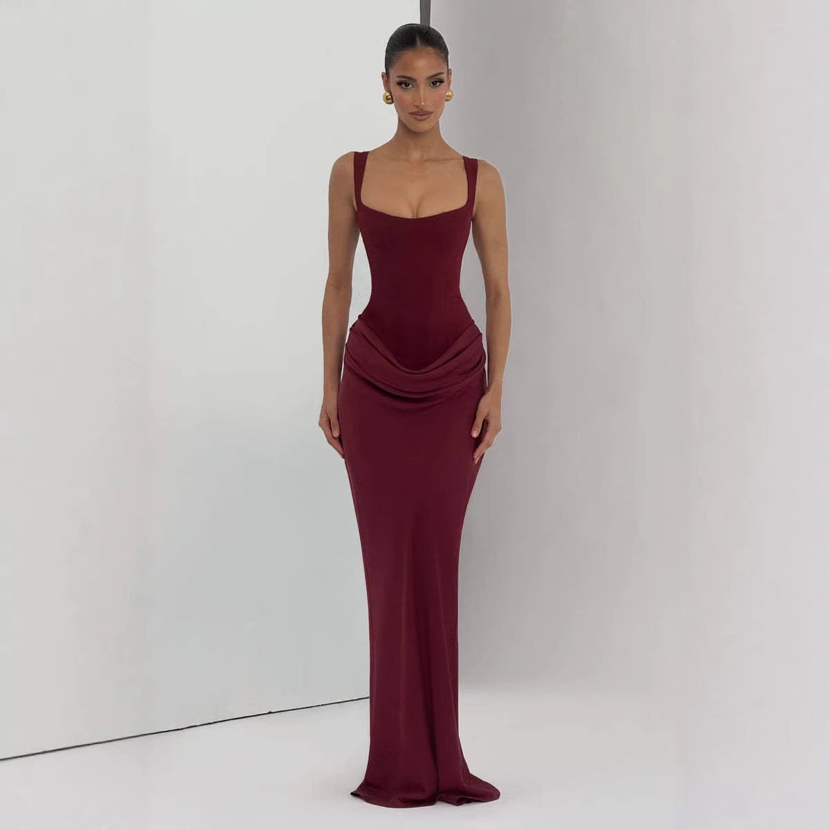 Strapless sleeveless sheath maxi dress in elegant fabric, designed by M Chic Boutique, displayed on a neutral background.