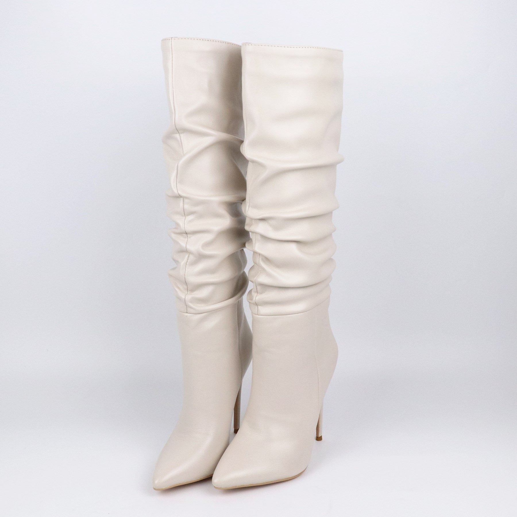 Black pleated pointed toe stiletto boots by M Chic Boutique, featuring sleek design and high heel for stylish footwear.