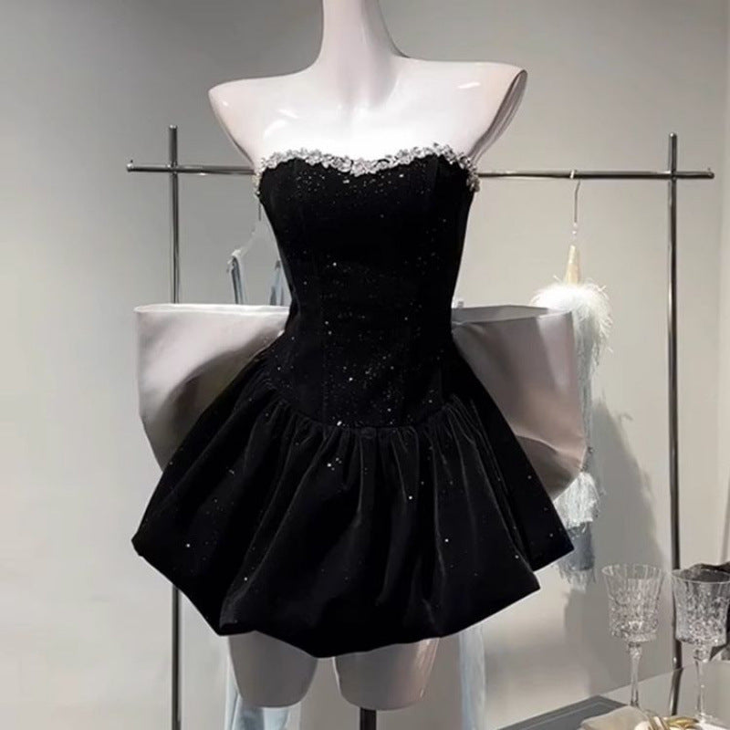 Elegant high-end light luxury dress with a bow detail from M Chic Boutique, featuring a flowing silhouette and soft fabric.