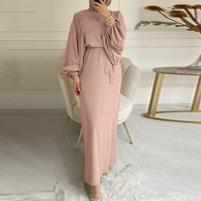Solid color elegant dress by M Chic Boutique displayed on a mannequin, showcasing its smooth fabric and flattering silhouette.
