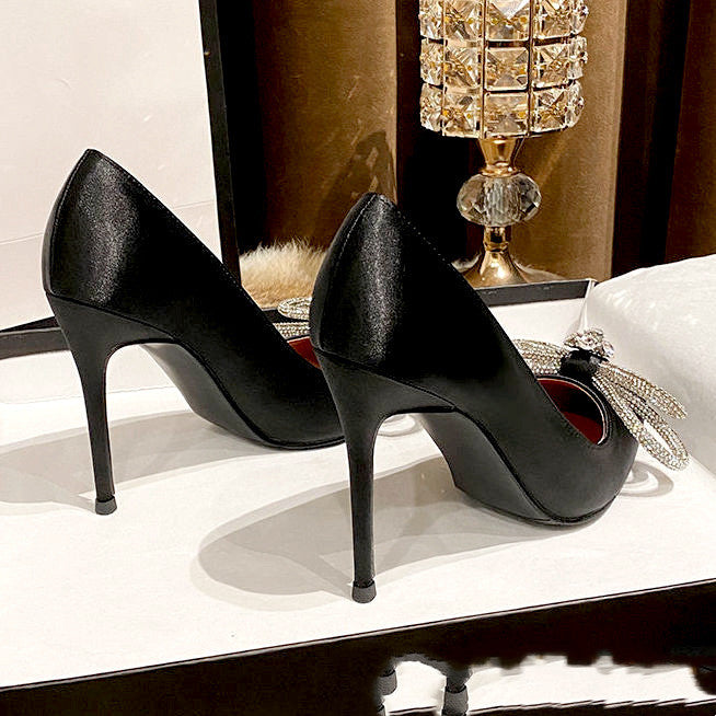 Rhinestone bow stiletto heel shoes from M Chic Boutique, featuring a sparkling bow detail and elegant pointed toe design.